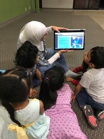Reading "Mommy, WhoIs Allah?' to the children at Define Academy. Summer Camp
